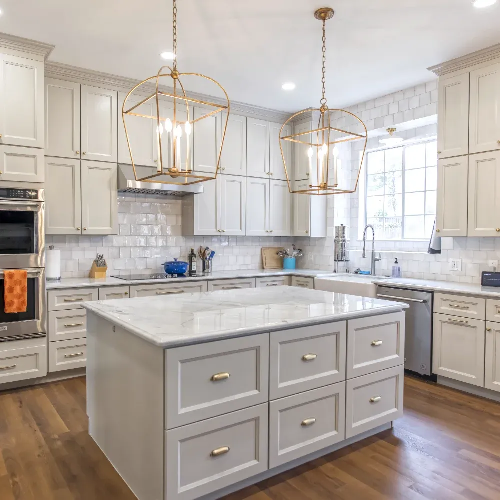 Traditional style kitchen with white cabinets, large island and black stainless steel fixtures