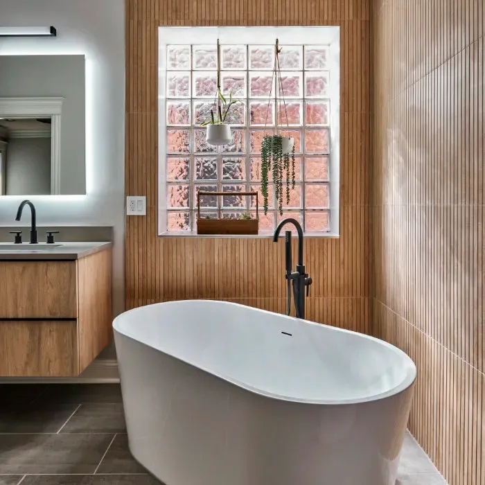 Natural spa-like bathroom with white freestanding tub and floating vanity