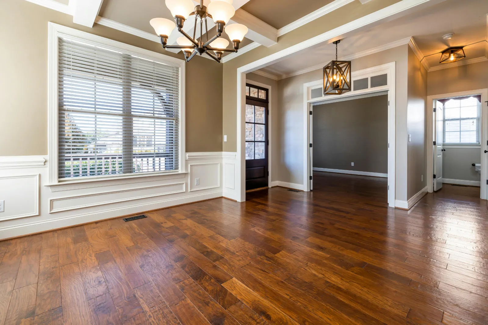 Dark wood-look luxury vinyl plank flooring flowing through an open dining and living area